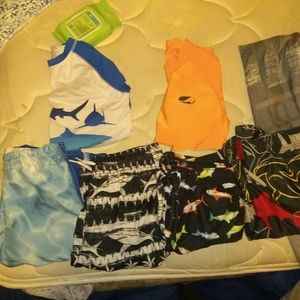 Bundle of boys rash guards and swim trunks